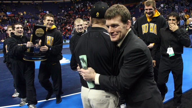 Iowa head coach Tom Brands gets a hug from mentor Dan Gable after Iowa won the 2008 NCAA Division 1 Wrestling Championships on March 22, 2008, at Scottrade Center in St. Louis.
