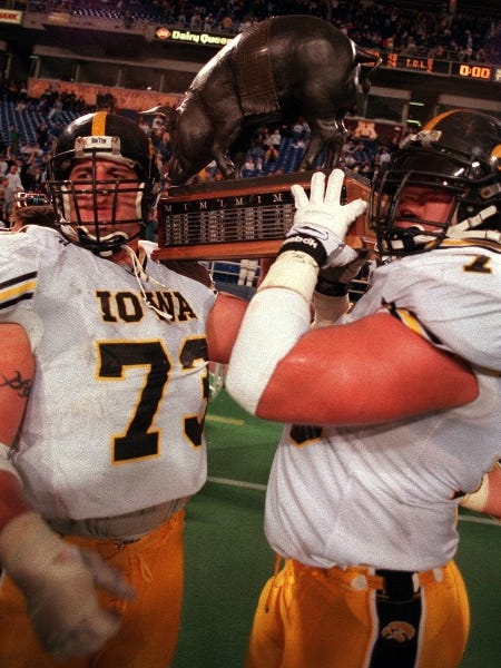 From 1996: Ross Verba, left, who happily hoisted the Floyd of Rosedale trophy with Iowa teammate Mike Goff after the Hawkeyes beat Minnesota, 43-24, says he is happy to play in the Alamo Bowl again.
