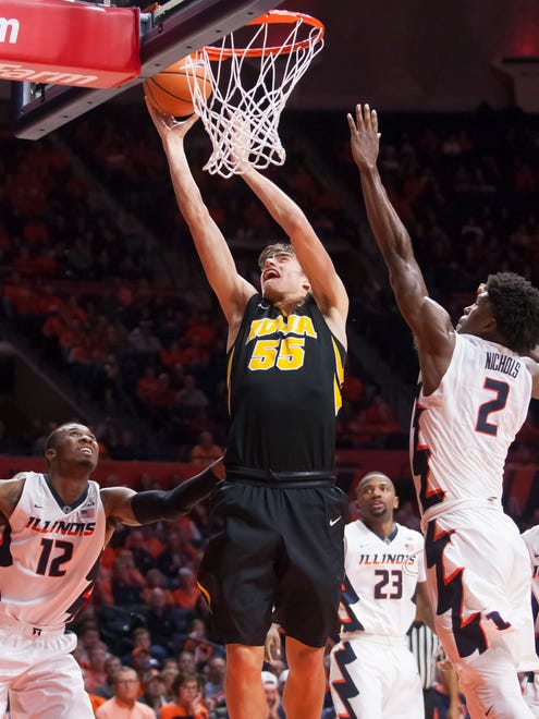 Jan 11, 2018; Champaign, IL, USA; Iowa Hawkeyes forward Luka Garza (55) shoots while defended by Illinois Fighting Illini forward Kipper Nichols (2) during the second half at State Farm Center. Mandatory Credit: Mike Granse-USA TODAY Sports
