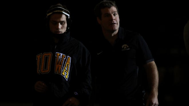 Iowa's Spencer Lee and head coach Tom Brands stand together during team introductions before their dual against Michigan State at Carver-Hawkeye Arena on Friday, Jan. 5, 2018.