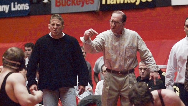 Iowa wrestling coach Dan Gable makes his point to his 158-pounder Daryl Weber during a first round match against Augsburg College's Jim Peterson at the National Dual Championships, Saturday, Jan. 20, 1996, in Lincoln, Neb. Next to Gable is assistant coach Royce Alger.