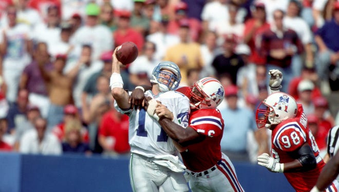 From 1993: New England Patriots linebacker (56) Andre Tippett hits Seattle Seahwks quarterback Kelly Stouffer (11) at Foxboro Stadium.
