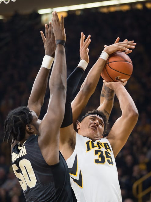 Iowa forward Cordell Pemsl (35) fights for a layup against Purdue forward Caleb Wanigan (50) in the first half at Carver Hawkeye Arena in Iowa City on Thursday, January 12, 2017.