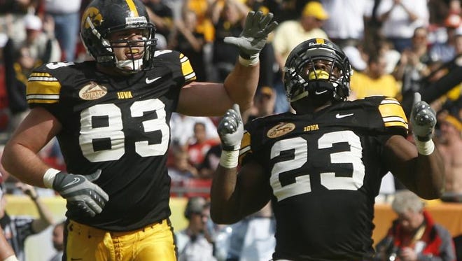 Iowa running back Shonn Greene, right, with teammate Brandon Myers celebrating Greene ' s touchdown against South Carolina in the 2009 Outback Bowl.