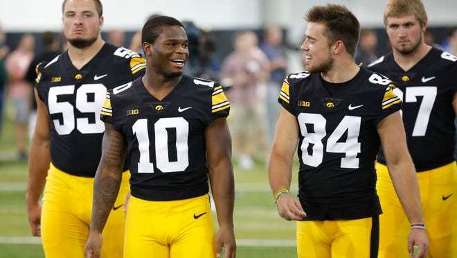 Iowa running back Mekhi Sargent (10) talks with wide receiver Nick Easley (84) during an NCAA college football media day, Friday, Aug. 10, 2018, in Iowa City, Iowa. (AP Photo/Charlie Neibergall)