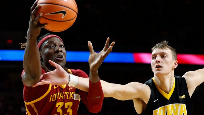 Iowa State forward Solomon Young (33) grabs a rebound in front of Iowa forward Jack Nunge during the first half of an NCAA college basketball game, Thursday, Dec. 7, 2017, in Ames, Iowa. (AP Photo/Charlie Neibergall)