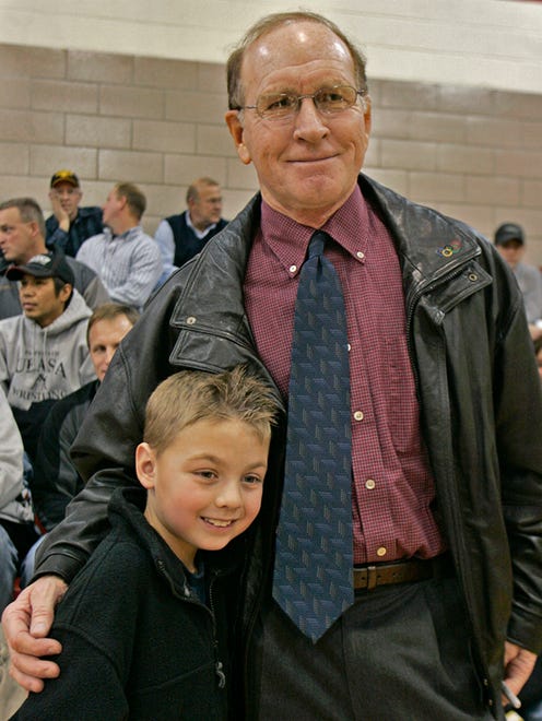 In this Dec. 3, 2008 photo, 7-year-old Mak Kaldenberg, of Johnston posed for a photo with former Iowa wrestling coach Dan Gable. Gable was the guest of honor at Grand View University's first-ever home wrestling meet.