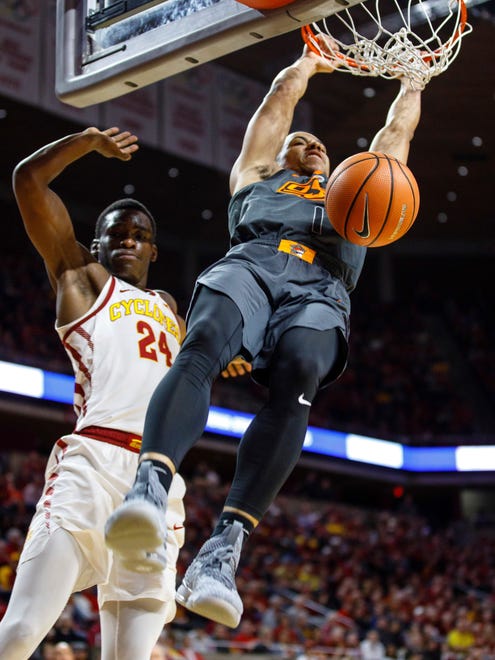 Oklahoma State's Kendall Smith (1) dunks on Iowa State's Terrence Lewis (24) during the second half of an NCAA college basketball game, Tuesday, Feb. 27, 2018, in Ames, Iowa. (AP Photo/Scott Morgan)