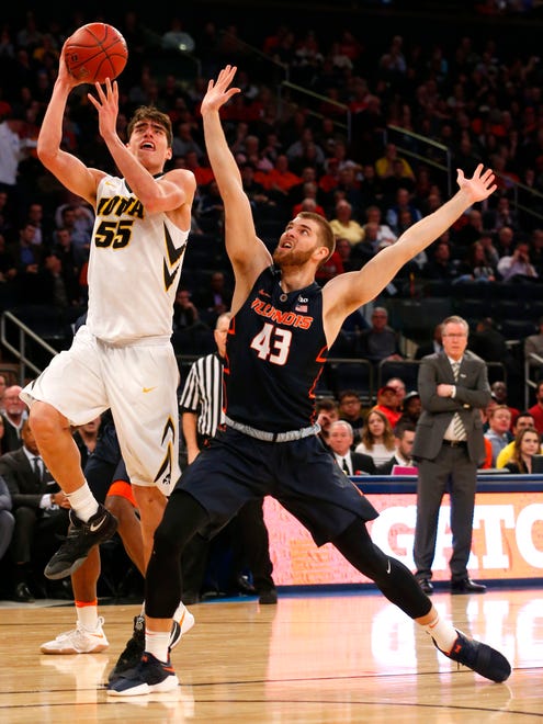 Iowa Hawkeyes forward Luka Garza (55) prepares to shoot the ball as Illinois Fighting Illini forward Michael Finke (43) defends during second half of a first game of the 2018 Big Ten Tournament at Madison Square Garden.