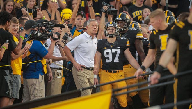 Iowa head football coach Kirk Ferentz stands with his team before they take the field prior to kickoff against Penn State on Saturday, Sept. 23, 2017, at Kinnick Stadium in Iowa City.