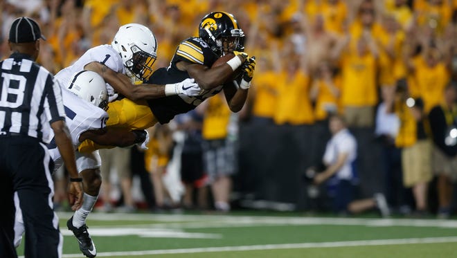 Iowa running back Akrum Wadley dives for a 70-yard touchdown during the Hawkeyes' game against No. 4 Penn State at Kinnick Stadium on Saturday, Sept. 23, 2017.