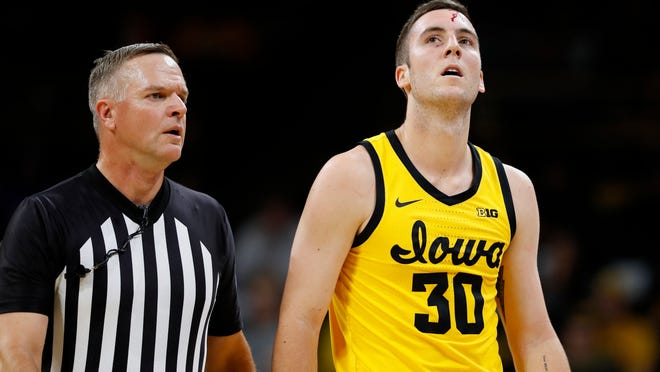 Iowa guard Connor McCaffery (30) walks to the bench after being injured during the first half of an NCAA college basketball game against DePaul, Monday, Nov. 11, 2019, in Iowa City, Iowa.(AP Photo/Charlie Neibergall)