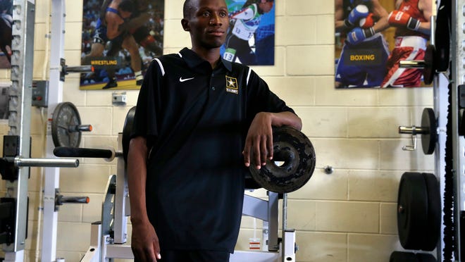 In this July 19, 2016 photo, Kenyan-born U.S. Army Sgt. Hillary Bor stands in the gym inside the U.S. Army's World Class Athlete Program, at Fort Carson Army Base, outside Colorado Springs, Colo. Bor and three other runners of Kenyan descent have taken a unique path to the Olympics through enlisting in the Army, earning U.S. citizenship, training with the military branch's World Class Athlete Program and making Team USA.  (AP Photo/Brennan Linsley)