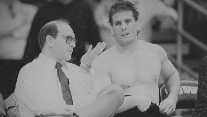 In this undated photo, Iowa wrestling coach Dan Gable confers with Mark Reiland.
