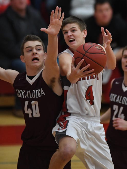Dallas Center-Grimes’ Trevor Grove goes up for a shot as Oskaloosa’s Cole Henry defends during a game on Jan. 27 at Dallas Center-Grimes High School.