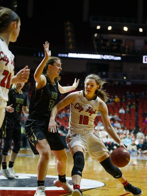 Iowa City, City High's Ashley Joens (10) drives around Iowa City, West's Paige Beckner (30) during the first half of their 5A state championship game at Wells Fargo Arena on Friday, March 2, 2018, in Des Moines. West takes a 21-16 lead into halftime.