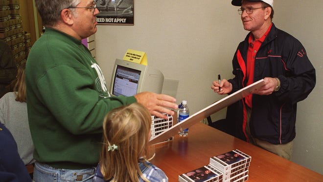 Dan Gable spent much of the day on Oct. 17, 1999 talking with wrestling fans like Clay Blanchard of Des Moines and signing autographs during the grand opening of InterMat Wrestling in Johnston.