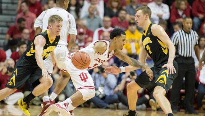 Indiana Hoosiers guard Devonte Green (11) dribbles the ball while Iowa Hawkeyes forward Jack Nunge (2) and guard Brady Ellingson (24) defend in the second half of the game at Assembly Hall.