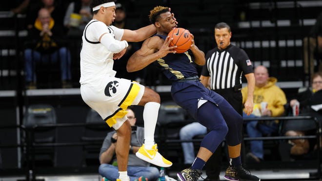 Oral Roberts forward Elijah Lufile drives around Iowa forward Cordell Pemsl, left, during the first half of an NCAA college basketball game, Friday, Nov. 15, 2019, in Iowa City, Iowa.(AP Photo/Charlie Neibergall)
