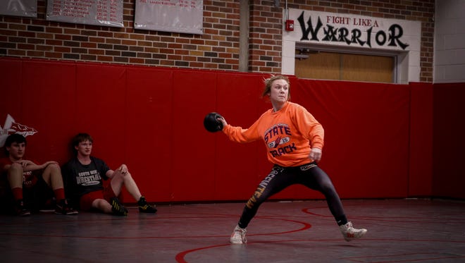 South Winneshiek junior wrestler Felicity Taylor plays a game of wall ball with her wrestling teammates before practice on Tuesday, Jan. 31, 2017, at the South Winneshiek High School wrestling room in Calmar, Iowa.