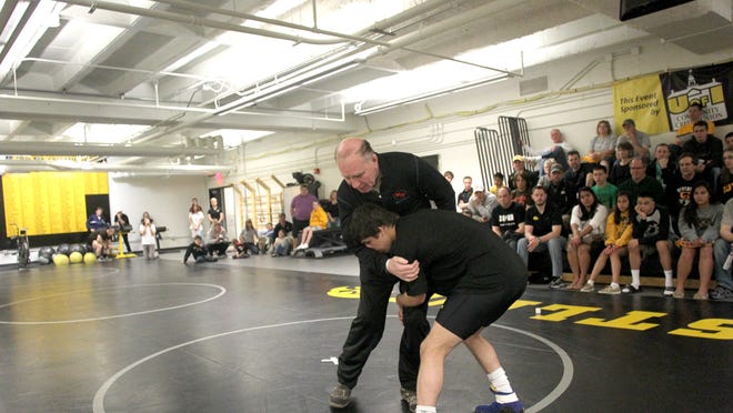 Dan Gable demonstrated with redshirt freshman Matt Gurule during a clinic explaining the difference in techniques and rules between folk style wrestling and freestyle wrestling at the Dan Gable Wrestling Complex on Saturday morning, April 7, 2012.