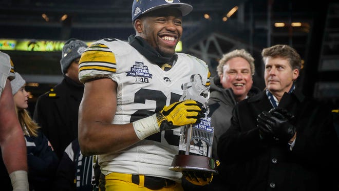 Iowa senior running back Akrum Wadley is all smiles after being presented with the player of the game trophy after helping the Hawkeyes to a 27-20 win over Boston College during the 2017 Pinstripe Bowl at Yankee Stadium in Bronx, New York on Wednesday, Dec. 27, 2017.