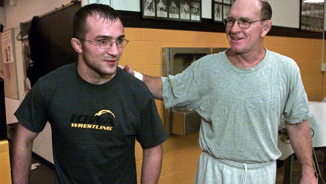 In this August of 2002 photo, Ryan Heim, who was in a coma for more than a month after a car crash in January 2002, is greeted by former Iowa wrestling coach Dan Gable.