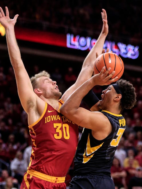 Iowa Hawkeyes forward Cordell Pemsl (35) puts up a shot while Iowa State Cyclones forward Hans Brase (30) defends as the Hawkeyes take on the Cyclones in Ames Thursday, Dec. 7, 2017.
