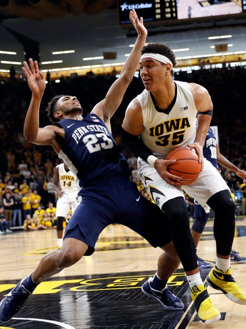 Iowa forward Cordell Pemsl (35) drives to the basket past Penn State guard Josh Reaves (23) during the second half of an NCAA college basketball game, Sunday, March 5, 2017, in Iowa City, Iowa. (AP Photo/Charlie Neibergall)