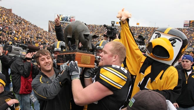 Iowa fans and players were very happy to keep the Floyd of Rosedale trophey as they celebrate their win over Minnesota 12-0.