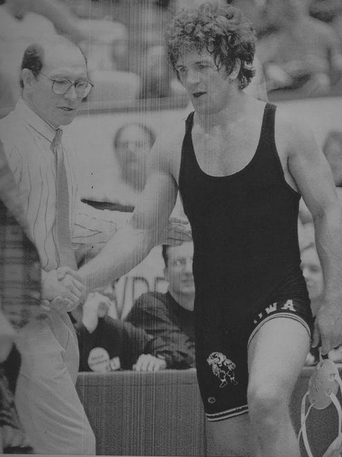 In this 1995 photo, Iowa coach Dan Gable is pictured with Ray Brinzer, who had just won a title in the Big Ten Conference tournament.