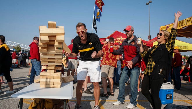 Eric Jess of Ankeny reacts after knocking over the oversized Jenga stack while tailgating prior to the CyHawk Series game between Iowa and Iowa State on Saturday, Sept. 9, 2017, at Jack Trice Stadium in Ames, Iowa.