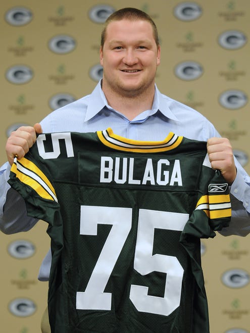 Green Bay Packers first-round draft choice Bryan Bulaga holds up his jersey during an introductory news conference on April 29, 2010, at Lambeau Field.