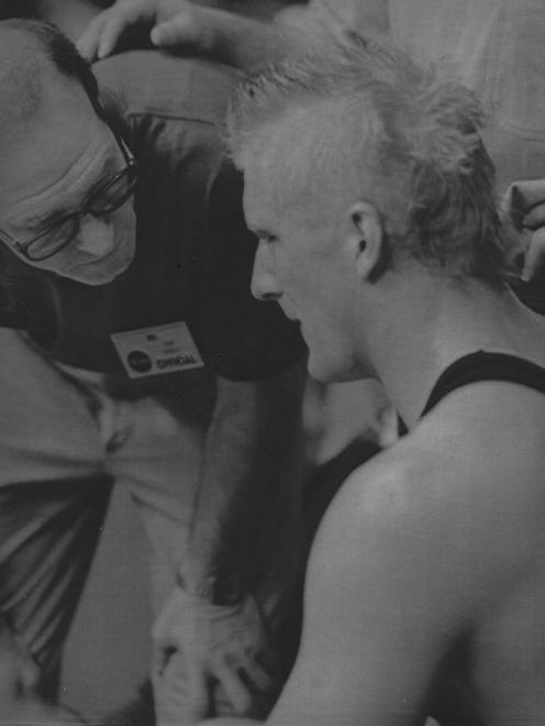 In this 1991 photo, Iowa wrestling coach Dan Gable talks with John Oostendorp.