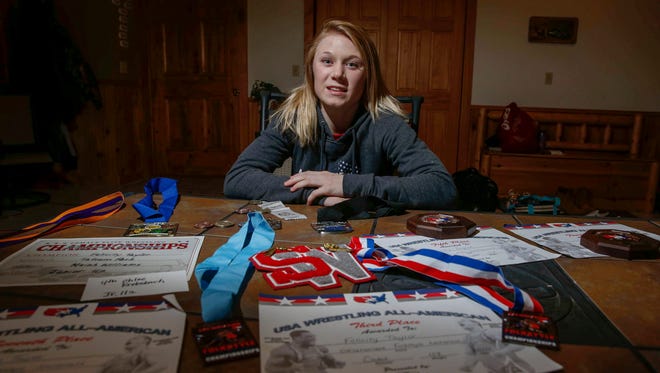 South Winneshiek junior Felicity Taylor poses with some of her wrestling medals and certificates at her home in Spillville, Iowa, on Tuesday, Jan. 31, 2017.