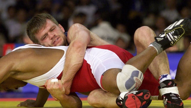 USA's Lincoln McIlravy takes down Nigeria's Ibo Oziti in a qualifying 69 kg freestyle wrestling match Sept. 29, 2000 at the Sydney Olympic Games. McIlravy won the match when Oziti forfeited by injury.
