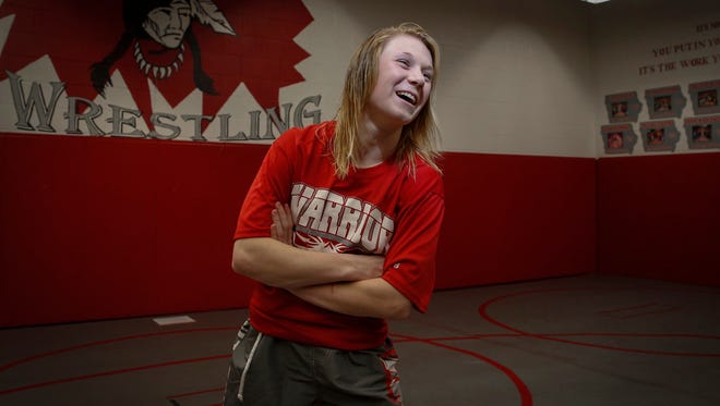 South Winneshiek junior Felicity Taylor laughs with teammates before posing for a photo on Tuesday, Jan. 31, 2017, at the South Winneshiek High School wrestling room in Calmar, Iowa.