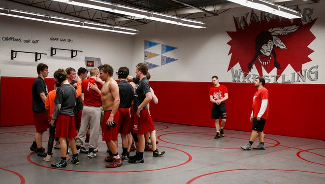 The South Winneshiek wrestling team gathers at the end of practice on Tuesday, Jan. 31, 2017, at the South Winneshiek High School wrestling room in Calmar, Iowa.