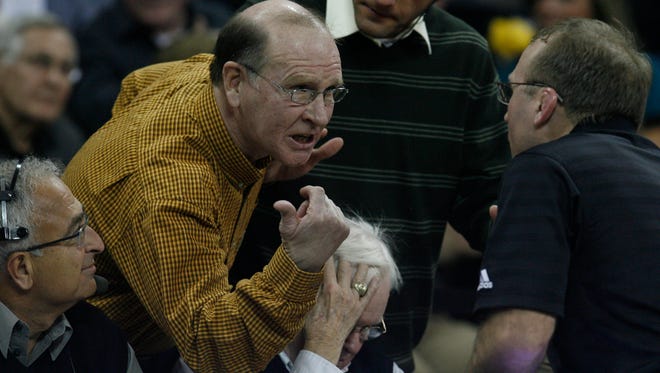 UI assistant to the Athletic Director Dan Gable argues with Wisconsin head coach Barry Davis during following the second overtime of the 165 pound match, Wednesday, Jan. 23, 2009, at Carver-Hawkeye Arena, in Iowa City.