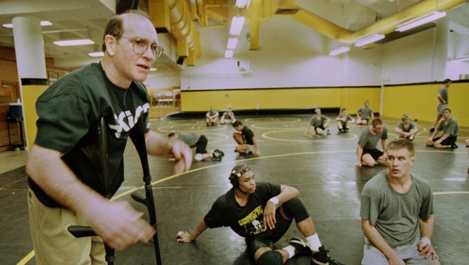 In this March 18, 1997 photo, Dan Gable instructs his wrestlers at the University of Iowa, among them Joe Williams, center and Justin Decker. Williams was a defending national champion.