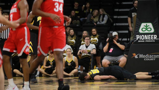 Iowa's Luka Garza lies on the ground after taking a big fall during the Hawkeyes' game against Ohio State at Carver-Hawkeye Arena on Thursday, Jan. 4, 2018.