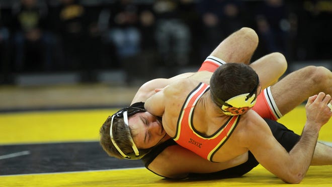 Iowa's Spencer Lee wrestles Oklahoma State's Nick Piccininni at 125 pounds at Carver-Hawkeye Arena on Sunday, Jan. 14, 2018. Lee won by decision, 10-5.