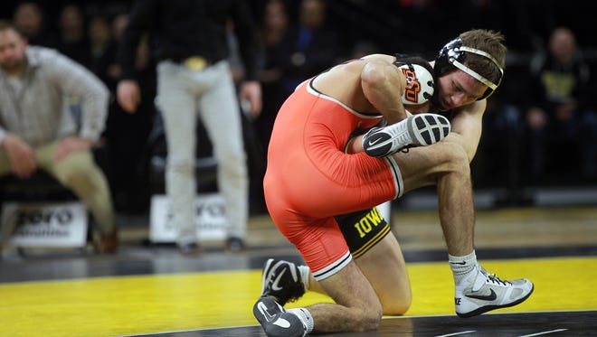 Iowa's Spencer Lee wrestles Oklahoma State's Nick Piccininni at 125 pounds at Carver-Hawkeye Arena on Sunday, Jan. 14, 2018. Lee won by decision, 10-5.