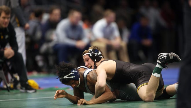 Iowa's Spencer Lee wrestles Chattanooga's Alonzo Allen at 125 pounds at the NCAA Wrestling Championships at Quicken Loans Arena in Cleveland, Ohio on Thursday, March 15, 2018. Lee won by tech fall, 18-0.