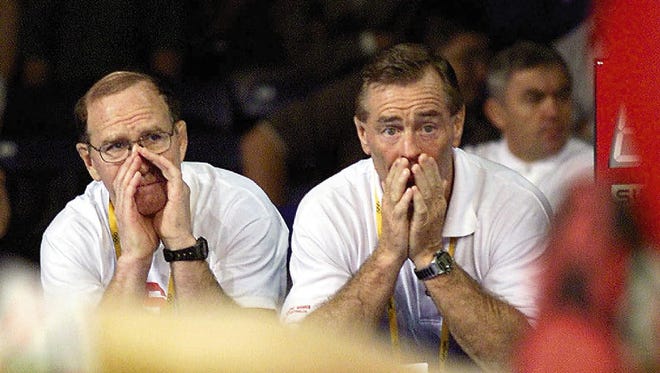 In this Oct. 13, 2000 photo, U.S. freestyle coaches Dan Gable, left, and Bruce Burnett offer direction to former University of Iowa Star Lincoln McIlravey during his win against Turkey's Yuksel Sanli.