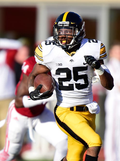 Iowa Hawkeyes running back Akrum Wadley (25) runs the ball in for a touchdown during the first quarter of the game against the Indiana Hoosiers at Memorial Stadium.