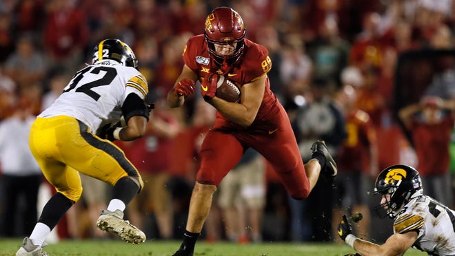 Iowa State tight end Charlie Kolar catches a pass between Iowa defenders Djimon Colbert, left, and Jack Koerner during the second half of an NCAA college football game Saturday, Sept. 14, 2019, in Ames, Iowa. Iowa won 18-17. (AP Photo/Charlie Neibergall)