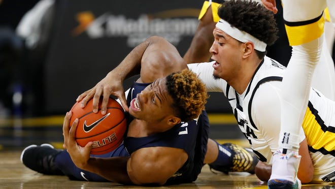 Oral Roberts forward Elijah Lufile, left, fights for the ball with Iowa forward Cordell Pemsl during the first half of an NCAA college basketball game, Friday, Nov. 15, 2019, in Iowa City, Iowa.(AP Photo/Charlie Neibergall)