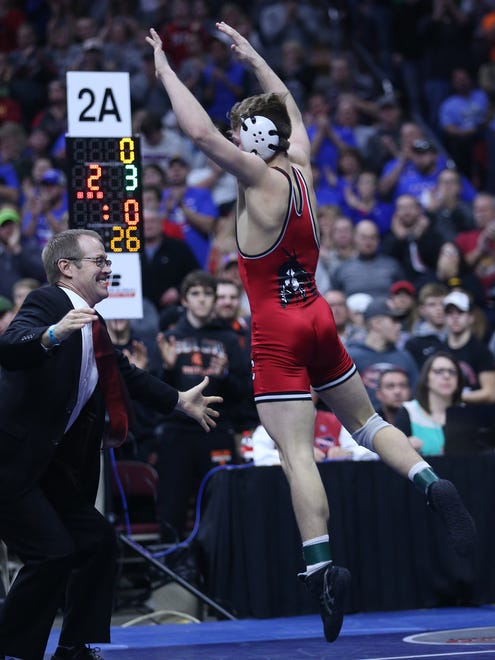 Pocahontas' Shea Ruffridge celebrates his win with his coach after his match against Clear Lake's Eric Faught during the championship round of the class 2A Iowa high school state wrestling tournament on Saturday, Feb. 17, 2018, in Wells Fargo Arena.