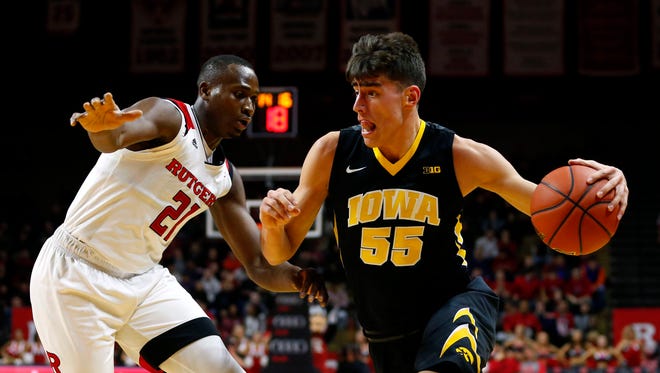 Jan 17, 2018; Piscataway, NJ, USA; Iowa Hawkeyes forward Luka Garza (55) drives to the basket against Rutgers Scarlet Knights forward Mamadou Doucoure (21) during first half at Louis Brown Athletic Center. Mandatory Credit: Noah K. Murray-USA TODAY Sports